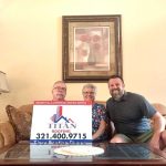 Family displaying Titan Roofing signage