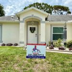 House featuring Titan Roofing signage in the front