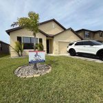 House with Titan Roofing sign in the front yard