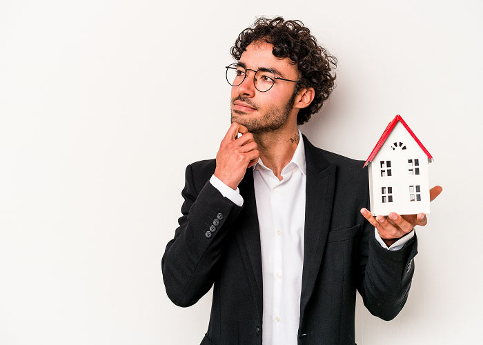Man holding a small model house