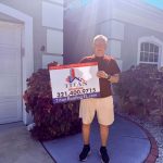 Man presenting a Titan Roofing sign