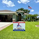 Sign for Titan Roofing placed in front of the house