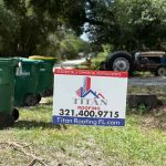 Titan Roofing sign adjacent to a garbage bin