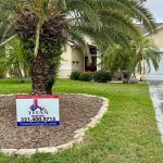 Titan Roofing sign placed near the trees in front of the house