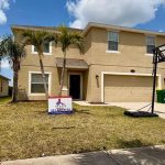 Titan Roofing sign positioned in front of the house
