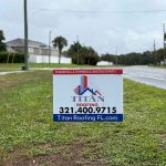 Titan Roofing signage positioned on a side road