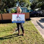 Woman holding a Titan Roofing sign