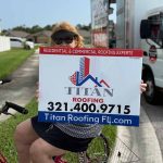 Woman on bicycle holding Titan Roofing sign