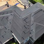 Aerial view of a house undergoing roof installation