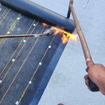 Asphalt shingles being installed