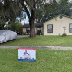 Titan Roofing sign displayed alongside a parked vehicle