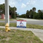 Titan Roofing sign standing at the street front
