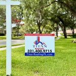 Titan Roofing sign with trees in the background