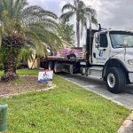 Titan Roofing signage alongside a materials delivery truck