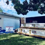 Titan Roofing signage alongside roofing materials