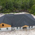 Under-construction house with asphalt shingles